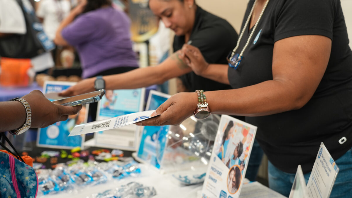 Child Action staff tabling community events. Our work is getting resources to parents and child care providers
