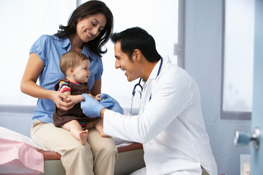 Doctor examining baby girl before giving the immunization