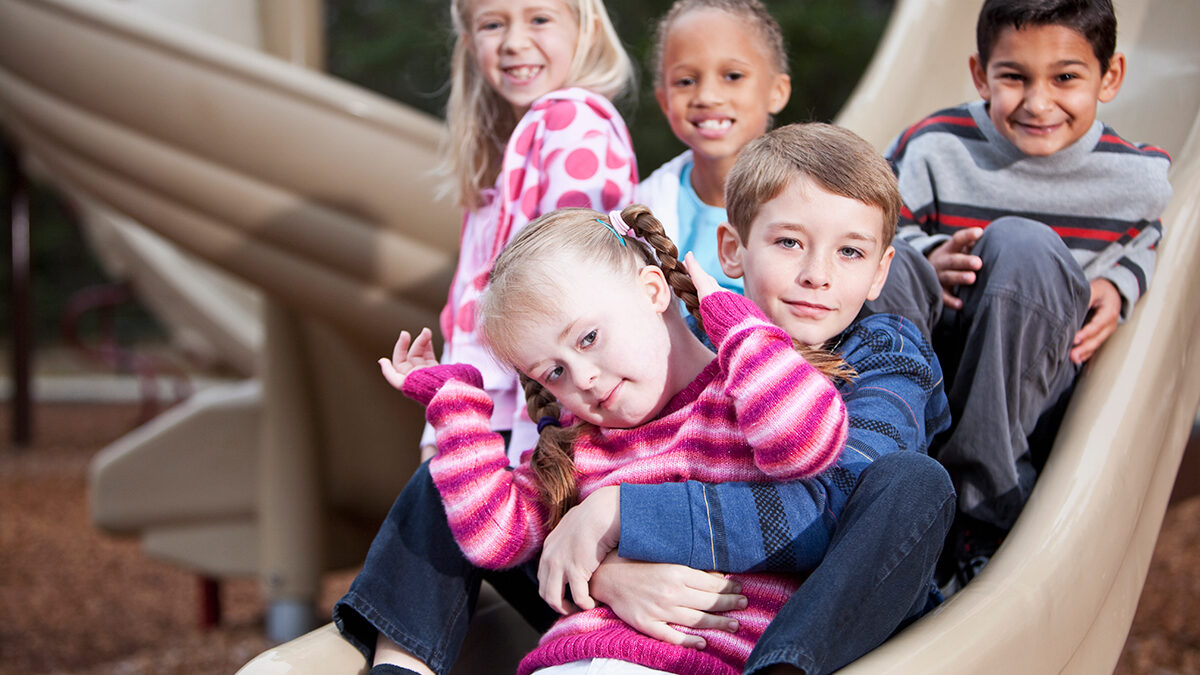 Young kids playing with a child with special needs