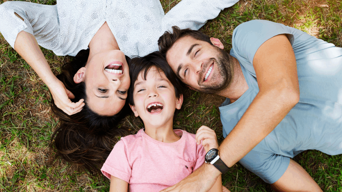 Smiling family with a mom, dad, and daughter